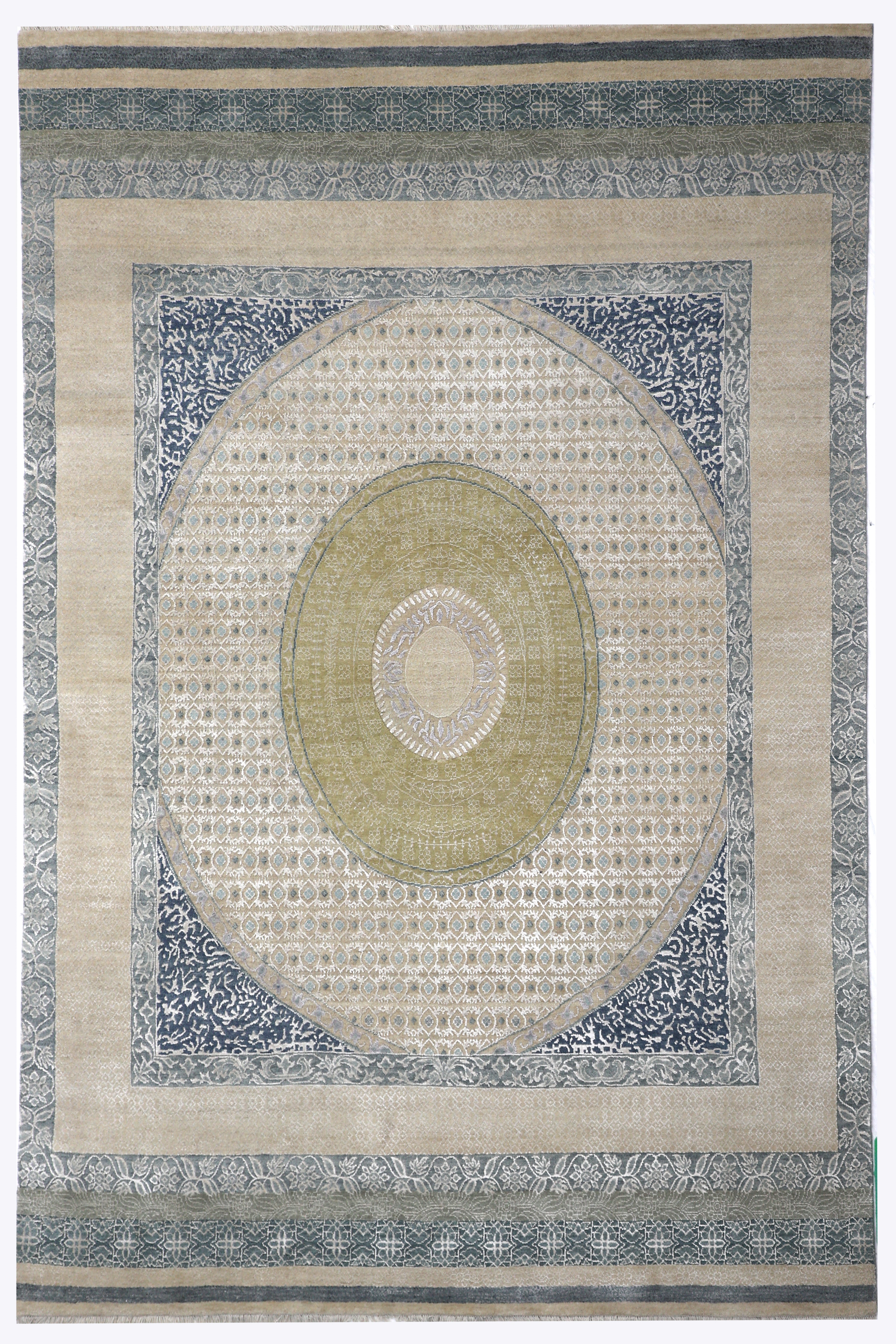 Ornate rectangular rug with a central green and beige medallion pattern, surrounded by intricate blue borders. The design is symmetrical and elegant.