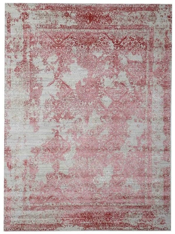 A vintage-style rug features a faded pink floral pattern on a muted gray background. The distressed design and intricate border evoke an antique, elegant feel.