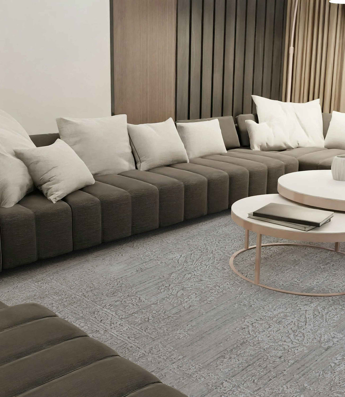 Modern living room with a grey sectional sofa on a detailed handmade grey area rug.