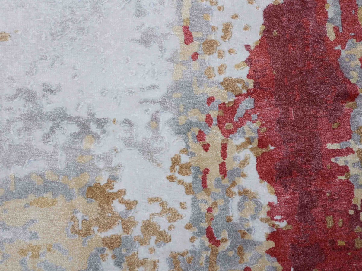 Abstract art with a textured, pixelated pattern. Muted red, gray, beige, and gold tones blend, creating a layered, dynamic yet calming atmosphere.